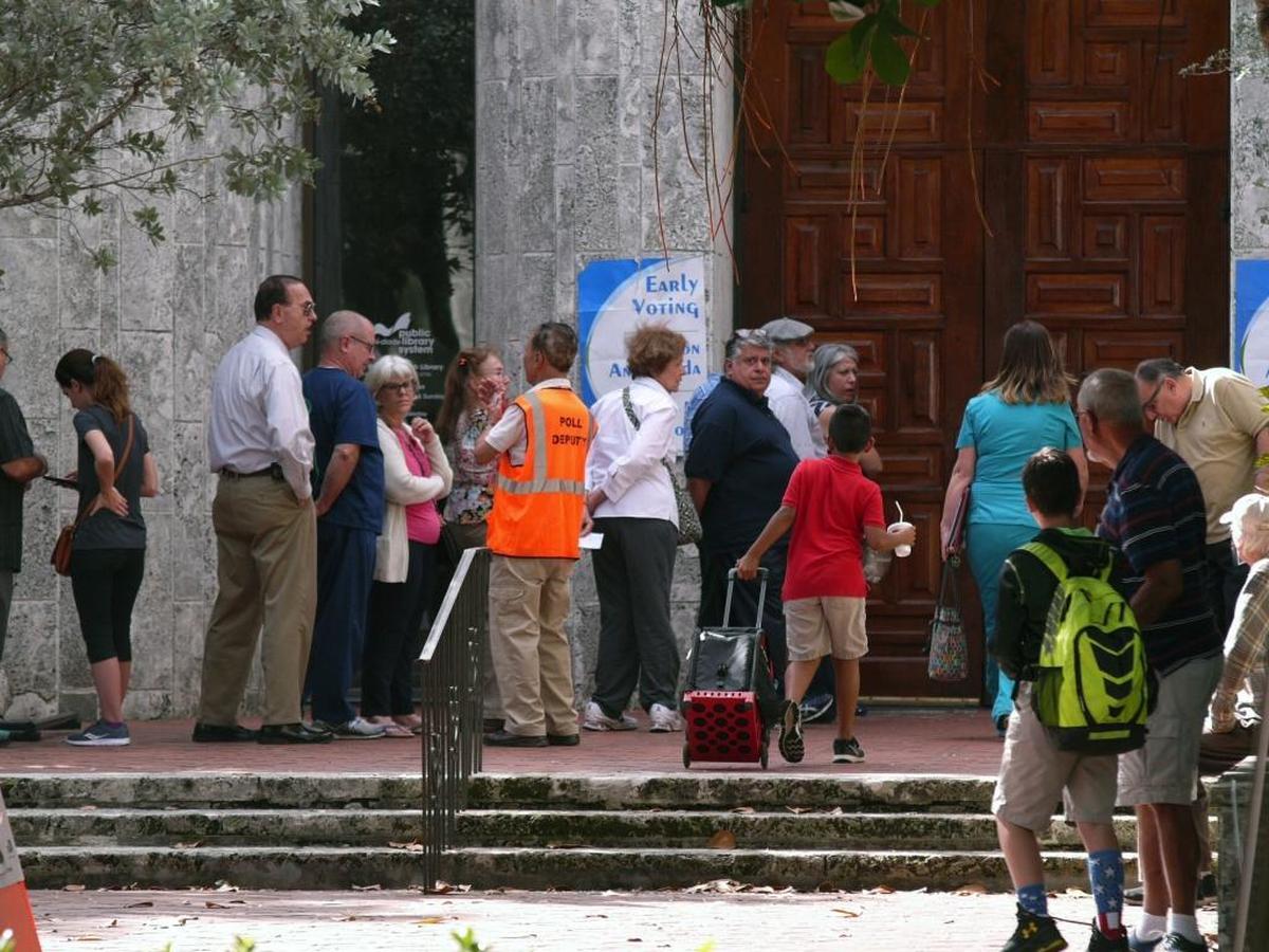 People stand in line waiting to vote at the early voting site at Coral Gables Library on Monday, October 24, 2016.