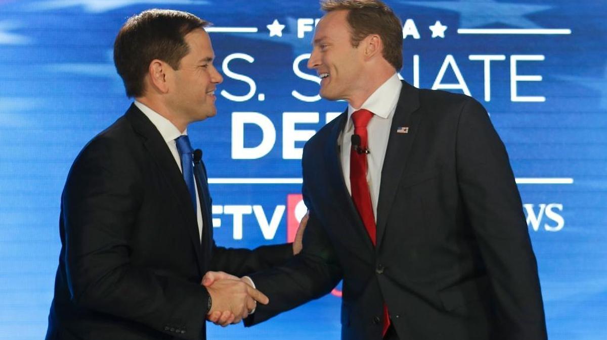 Republican incumbent Sen. Marco Rubio, left, and Democratic challenger Rep. Patrick Murphy shake hands before their debate at the University of Central Florida, Monday, Oct. 17, 2016, in Orlando.