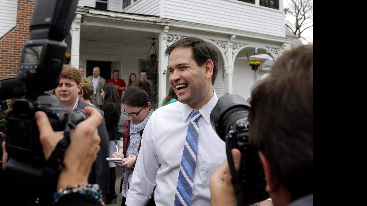 
Marco Rubio laughs as he is surrounded by media at a campaign house party in Manchester, N.H.
