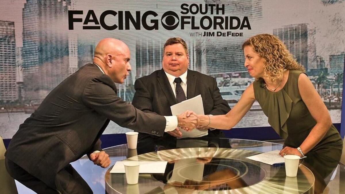 U.S. Congressional candidate Tim Canova and U.S. Rep. Debbie Wasserman Schultz shake hands after they debated each other on CBS4's Facing South Florida with Jim De Fede on Sunday , August 14, 2016.