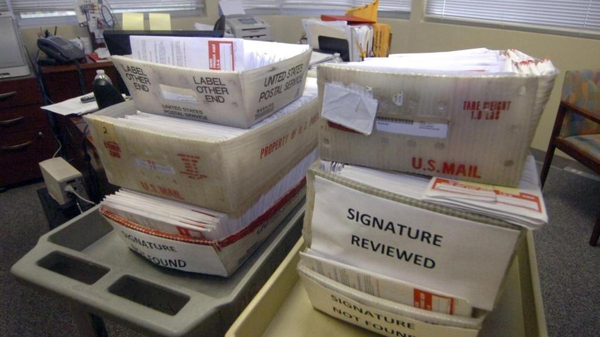 In this 2012 file photo, boxes containing about 2,000 rejected absentee ballots sit at Miami-Dade Elections Department, mostly for lack of signatures or review of signatures.