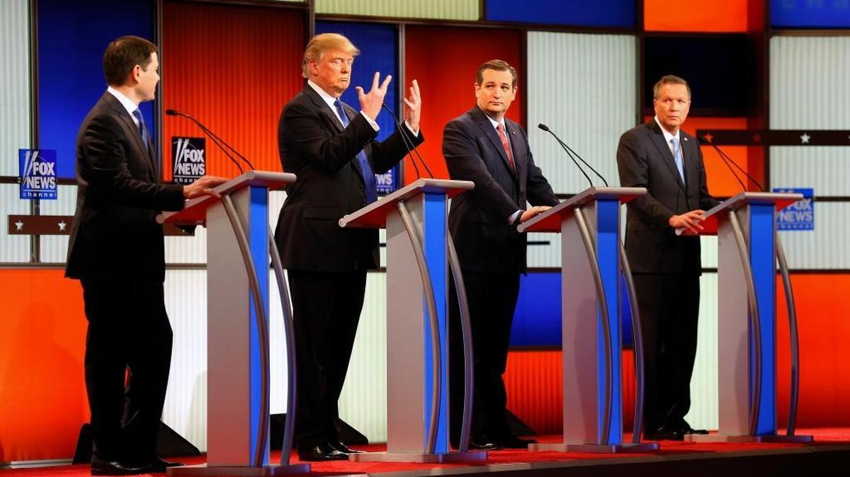 Republican presidential candidate Donald Trump, second from left, gestures as opponents Marco Rubio,Ted Cruz and John Kasich watch him at the Republican presidential primary debate at Fox Theatre on Thursday in Detroit.