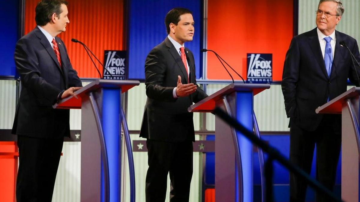 Republican presidential candidate Sen. Marco Rubio, R-Fla., center, answers a question as Sen. Ted Cruz, R-Texas, left, and former Florida Gov. Jeb Bush, right, listen during a Republican presidential primary debate, Thursday, Jan. 28, 2016, in Des Moines, Iowa.