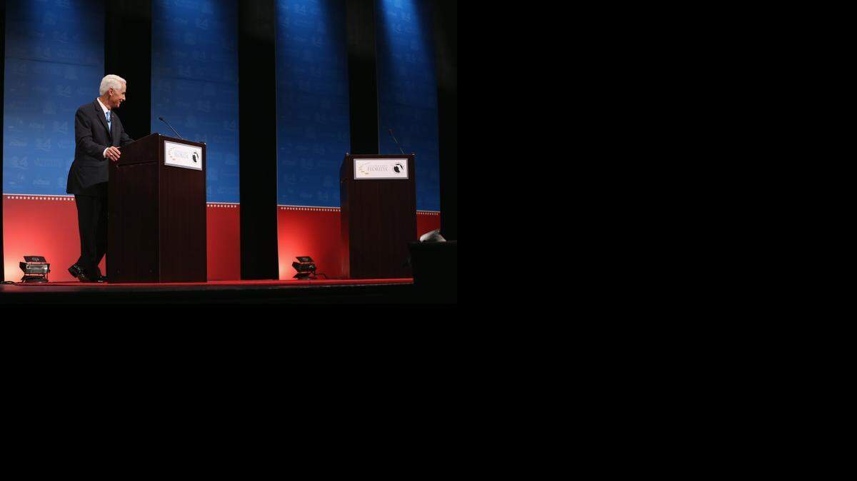 
Former Florida Gov. Charlie Crist waits next to an empty podium for Republican Florida Governor Rick Scott, who at first refused to participate in a gubernatorial debate due to an Crist’s use of an electric fan.
