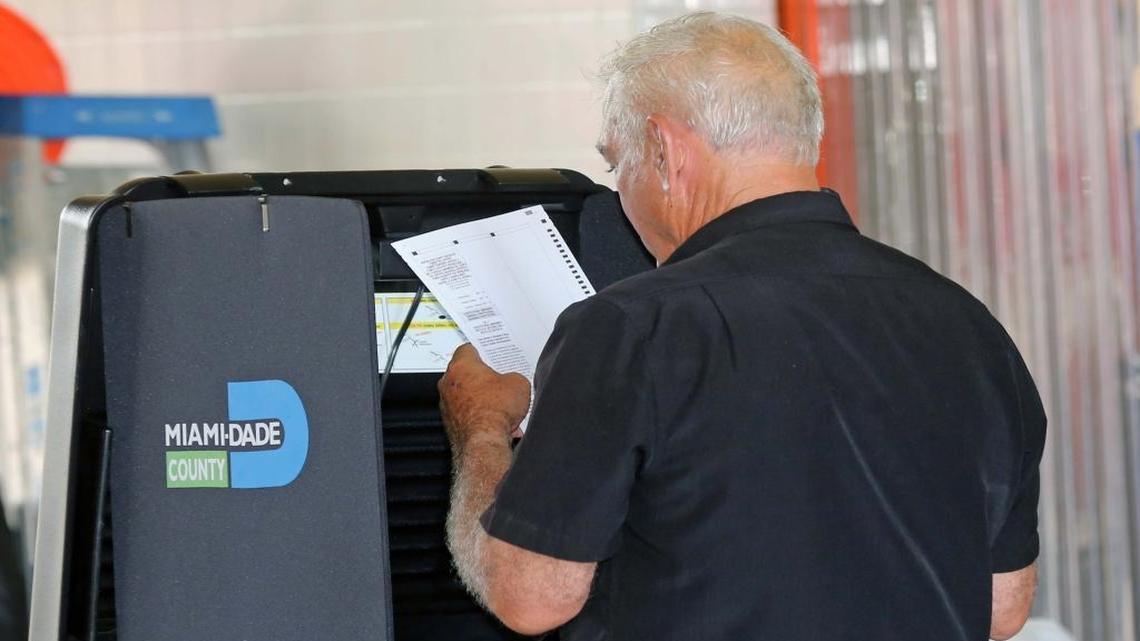 A Hialeah voter double-checks his ballot before submitting it on Tuesday, August 30, 2016.