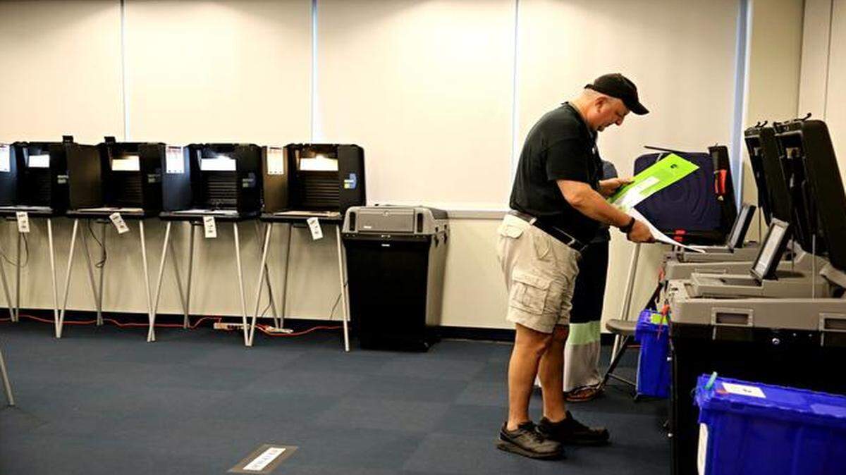 
Miami Beach resident, Michael Frank, casts his ballot at the Miami Beach Training Center during early voting Monday morning, August 11, 2014.
