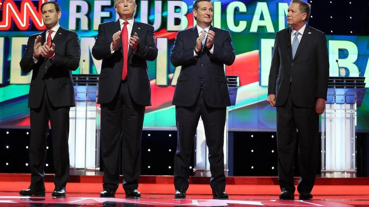 Republican presidential candidates Marco Rubio, Donald Trump, Ted Cruz and John Kasich stand up for the national anthem during the Republican presidential primary debate at the University of Miami on Thursday.