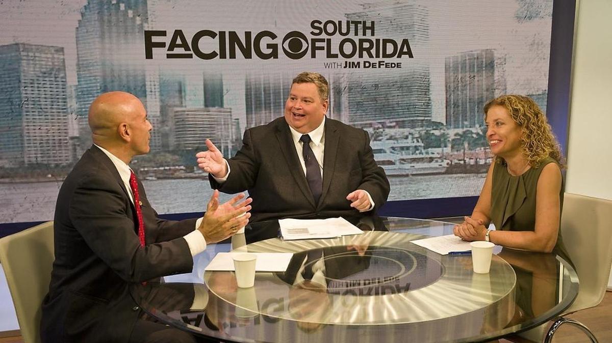 Jim DeFede moderates a debate between U.S. Congressional candidate Tim Canova, left, and U.S. Rep. Debbie Wasserman Schultz on CBS4’s ‘Facing South Florida’ in 2016. A new documentary by DeFede, a journalist with CBS Miami, explores the life and death of a mentally ill inmate in a Florida prison in Miami-Dade.