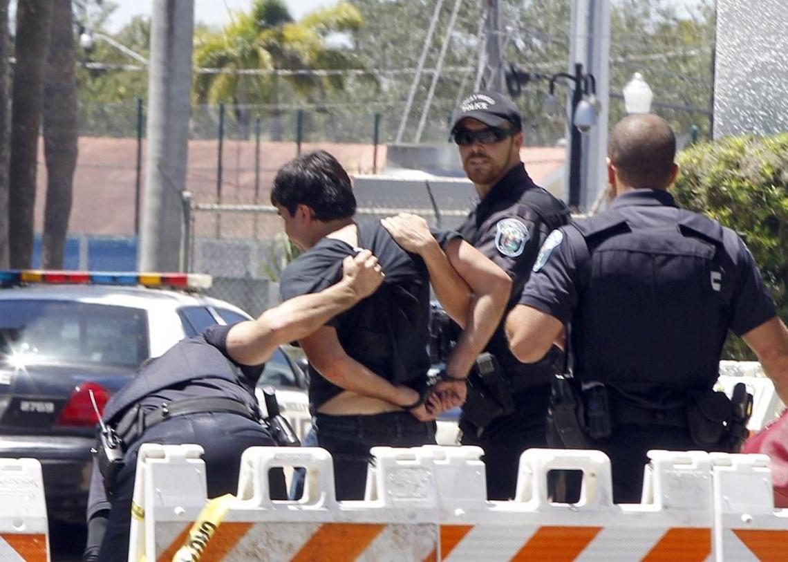 Christopher Rey Monzon, 22, of Hialeah, is arrested by Hollywood Police on charges of disorderly conduct, aggravated assault and inciting a riot after he crossed through police tape to confront activists marching outside Hollywood City Hall on Wednesday, Aug. 30, 2017. The city commission was scheduled to vote on whether to rename streets that are currently named for Confederate generals.