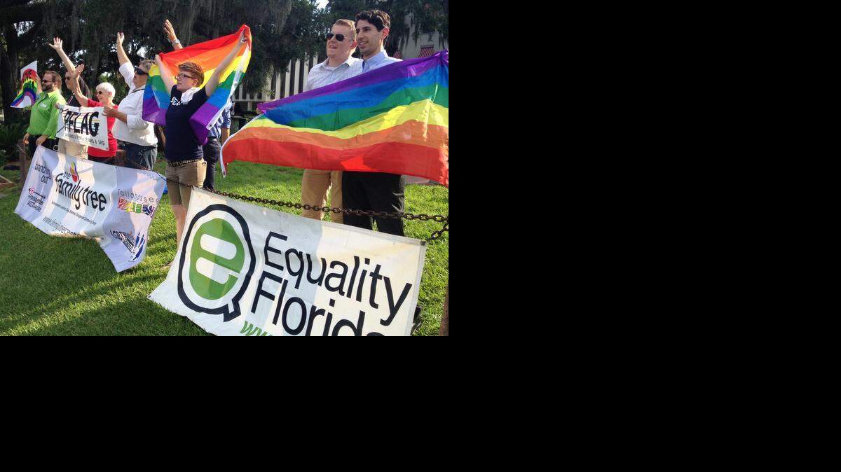 
Gay marriage supporters celebrate a ruling in front of the Old Florida Capitol in Tallahassee, July 17, 2014.
