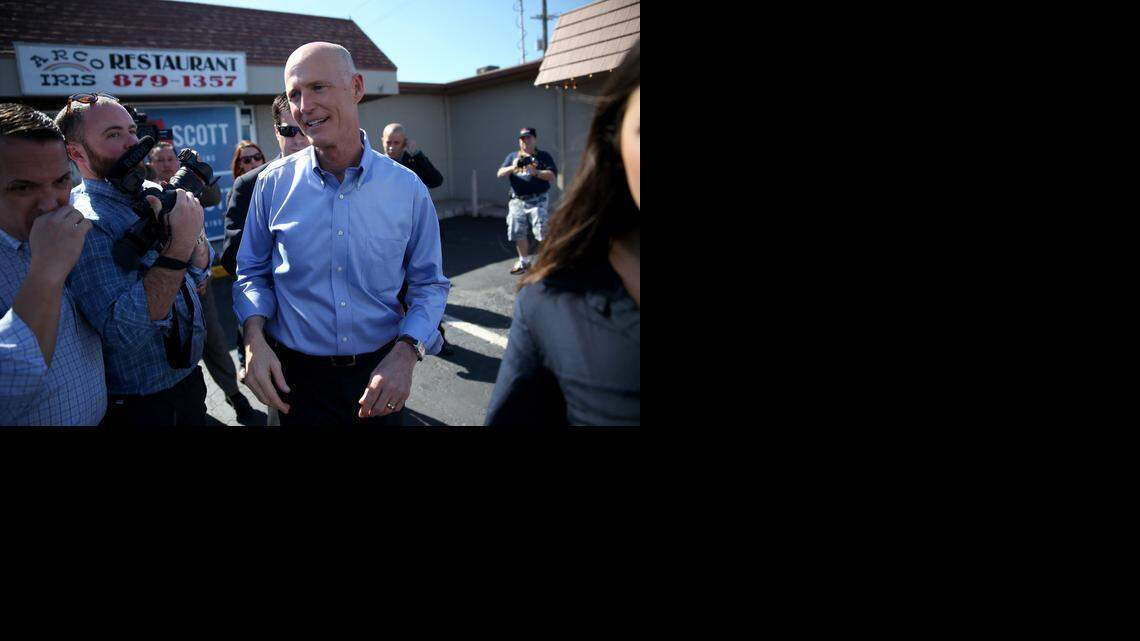 
Florida Gov. Rick Scott greets people as he campaigns at the Arco-Iris restaurant on November 4, 2014 in Tampa.
