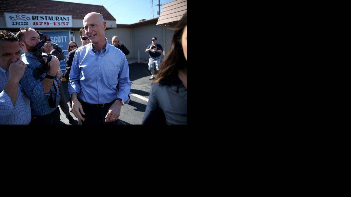 
Florida Gov. Rick Scott greets people as he campaigns at the Arco-Iris restaurant on November 4, 2014 in Tampa.

