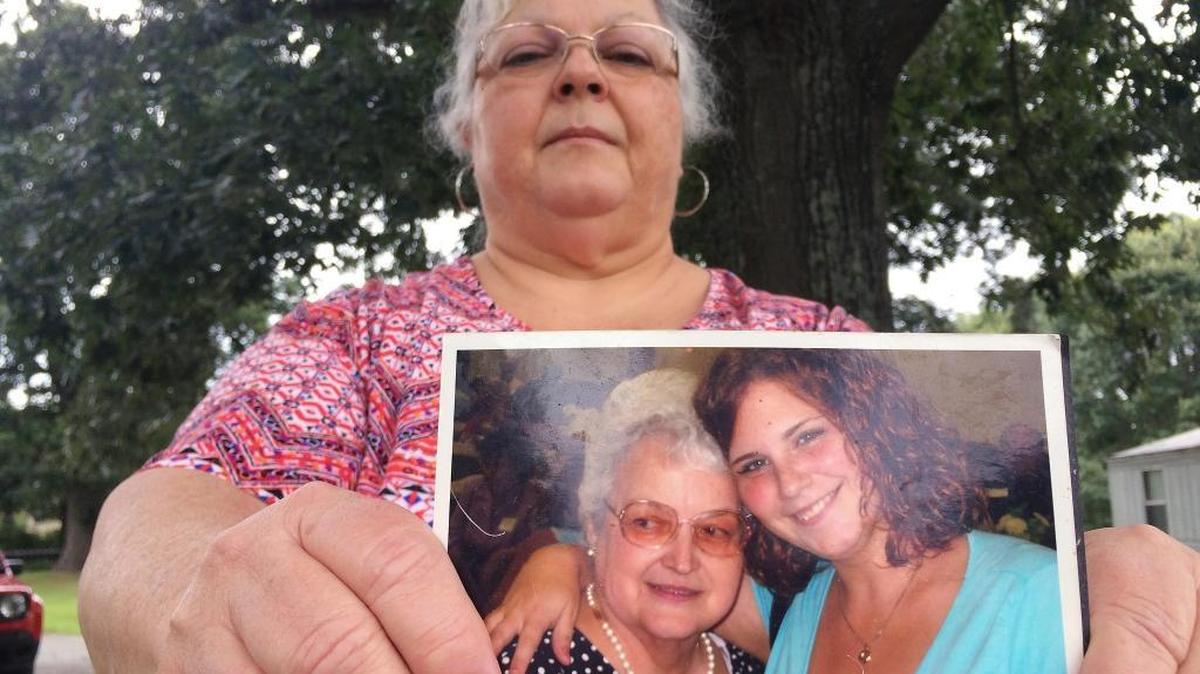 Susan Bro, the mother of Heather Heyer, holds a photo of Bro's mother and her daughter on Monday in Charlottesville, Va. Heyer was killed Saturday when police say a man plowed his car into a group of demonstrators protesting the white nationalist rally. Bro said that she is going to bare her soul to fight for the cause that her daughter died for.