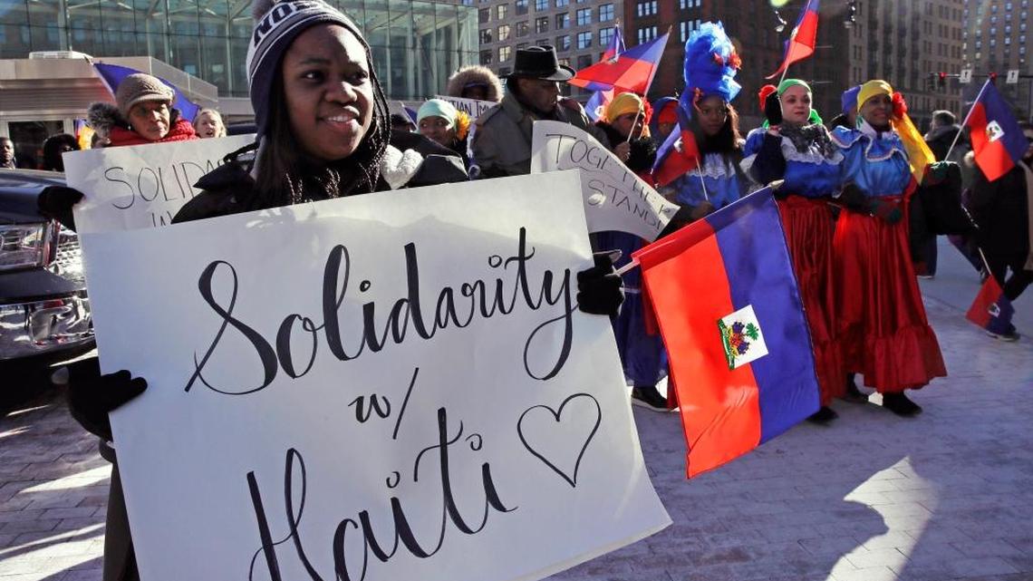 Haitian activists and immigrants protest on City Hall Plaza in Boston, Friday, Jan. 26, 2018. Haitian community leaders complained last week that the Trump administration's delays in re-registering those living in the U.S. legally through the Temporary Protected Status program would lead to job losses, travel problems and other issues for Haitians.
