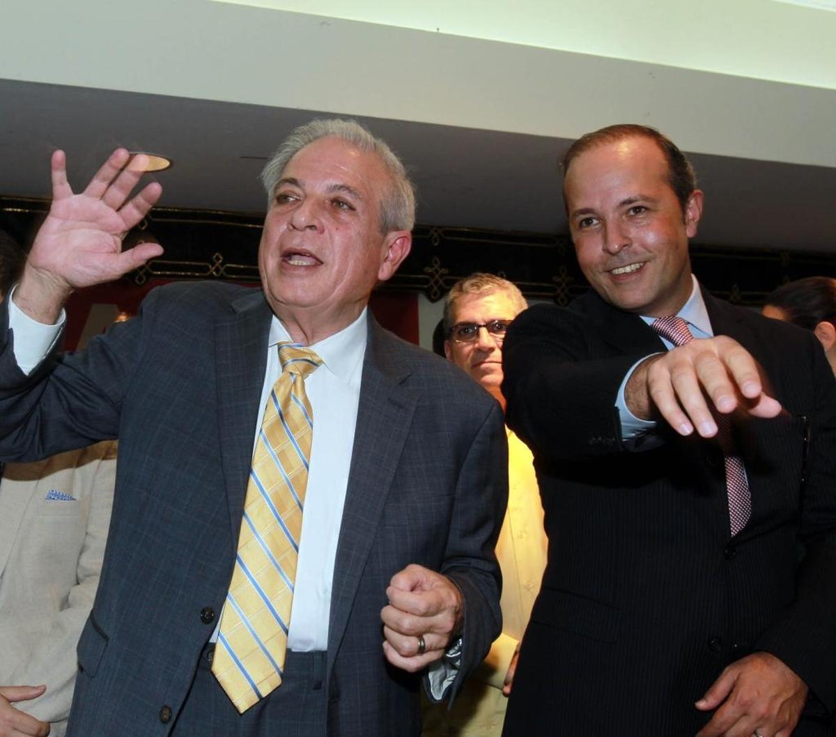 Miami Mayor Tomas Regalado celebrates his re-election victory with his son Tommy Regalado in 2013.