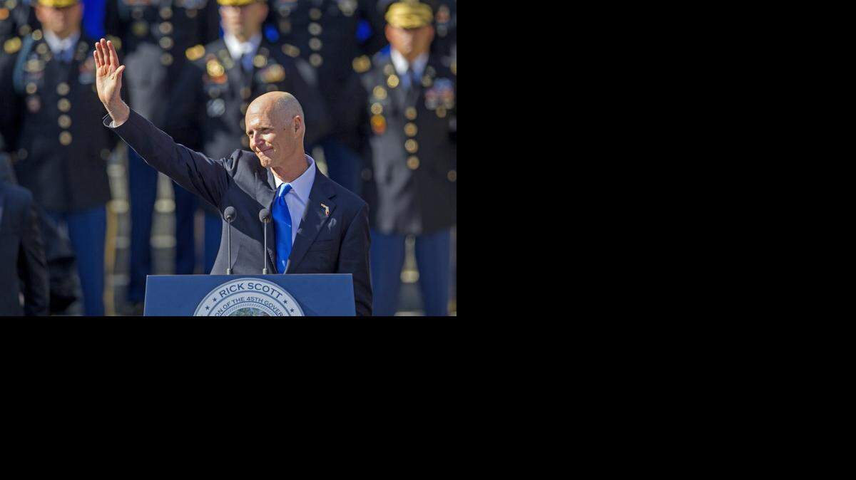 
Florida Gov. Rick Scott waves on Tuesday after the swearing in for his second term as governor of Florida at the Florida state capitol in Tallahassee. The inauguration took place in front of the Old Capitol. 
