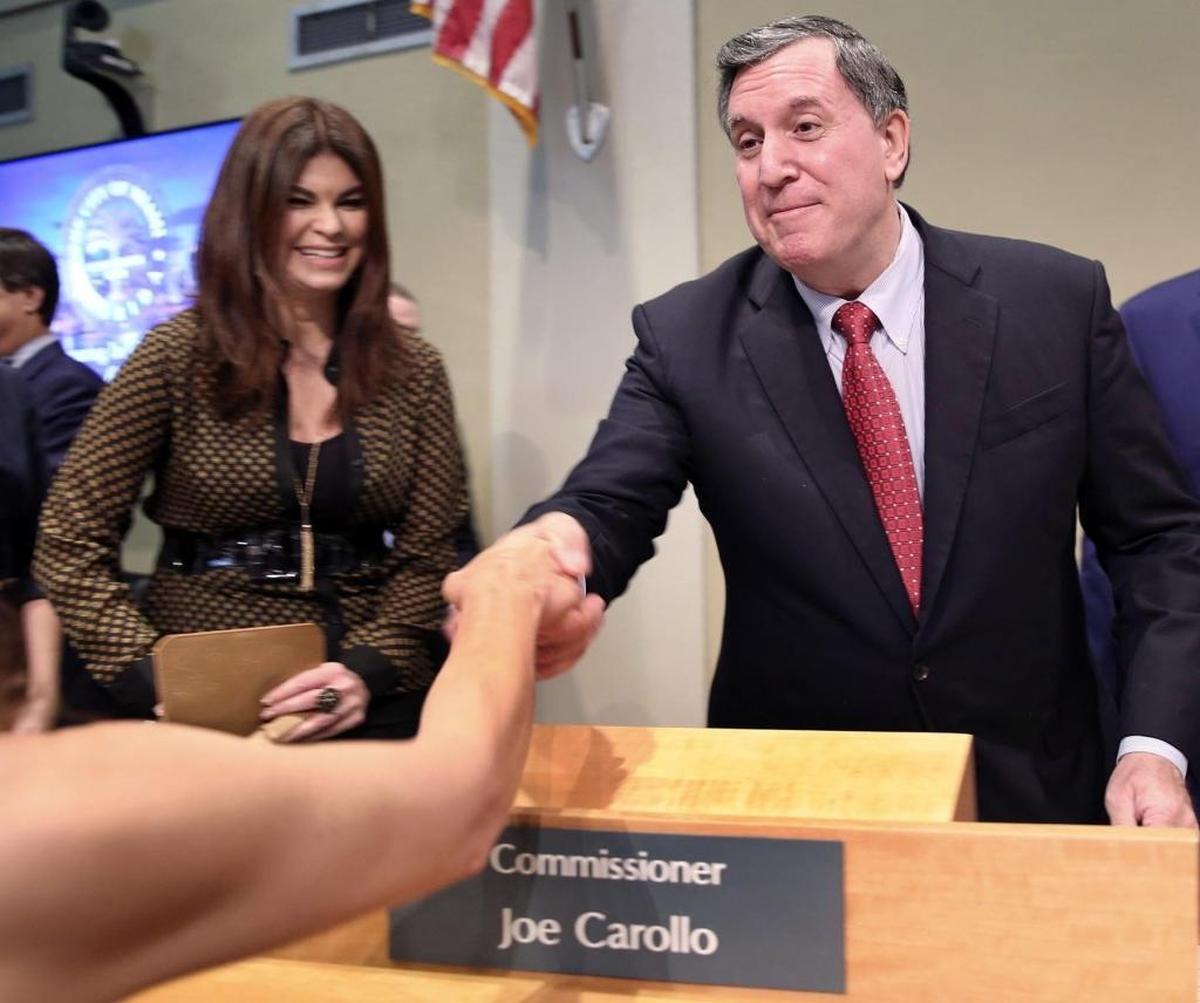 Joe Carollo is congratulated by supporters after being sworn in on Dec. 2, 2017, as the newly elected Miami city commissioner, as his wife, Marjorie Carollo, looks on.