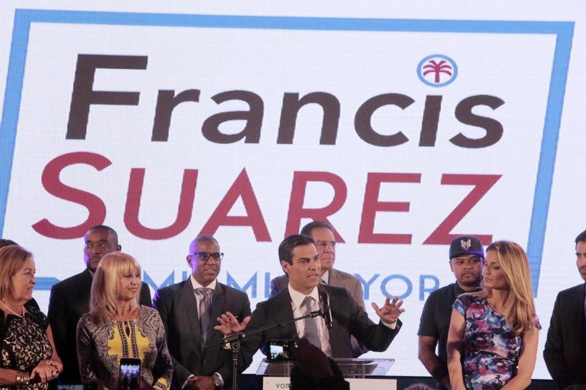 Francis Suarez, (center), surrounded by family and friends, speaks to his supporters at the victory party at the Omni Hilton in Miami.