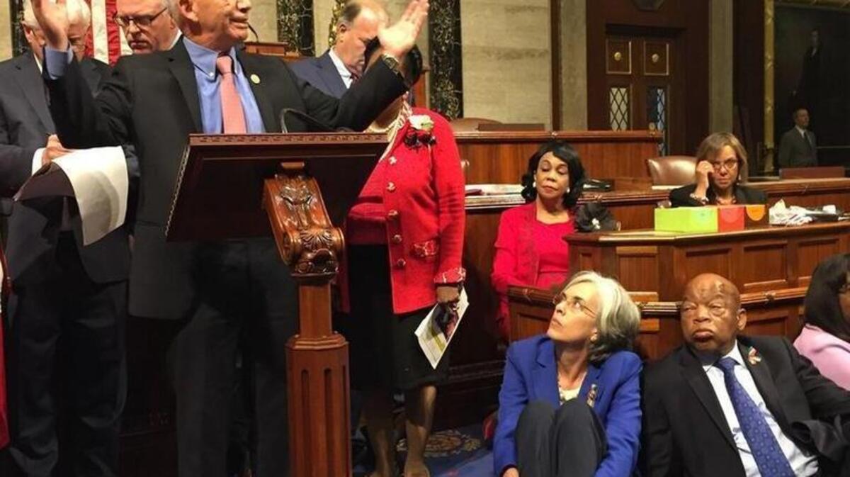 This photo provided by Rep.Suzanne Bonamici, D-Ore., shows Democrat members of Congress, including, from left, Rep. Peter DeFazio, D-Ore., Rep. Katherine Clark, D-Mass., and Rep. John Lewis, D-Ga.,participating in sit-down protest seeking a a vote on gun control measures on Wednesday on the floor of the House.