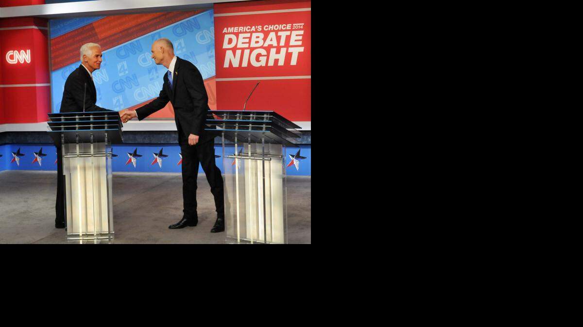 
Democratic candidate Charlie Crist, left, and Republican Gov. Rick Scott shake hands before their live television debate, Tuesday, Oct. 21, 2014 hosted by WJXT-TV and CNN at the Channel 4 studios in Jacksonville.
