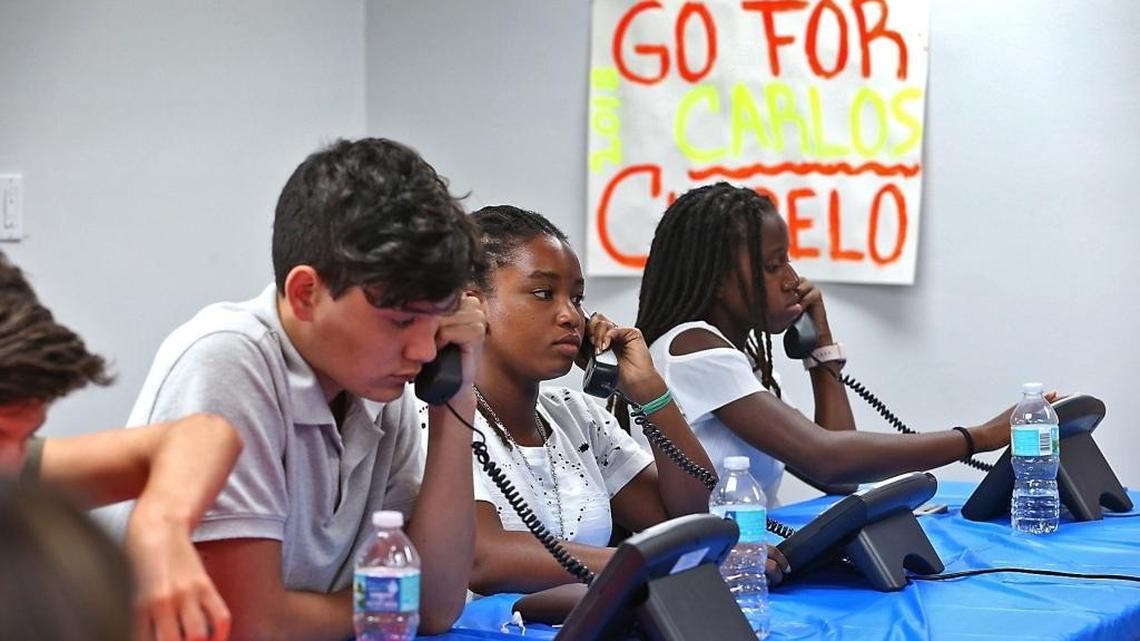 Victor Bisbal, 15; Batiah Sinepha, 16, and Souline Mervil, 14, work the phones at Congressional Leadership Fund’s West Kendall office, opened to help reelect Republican Rep. Carlos Curbelo.