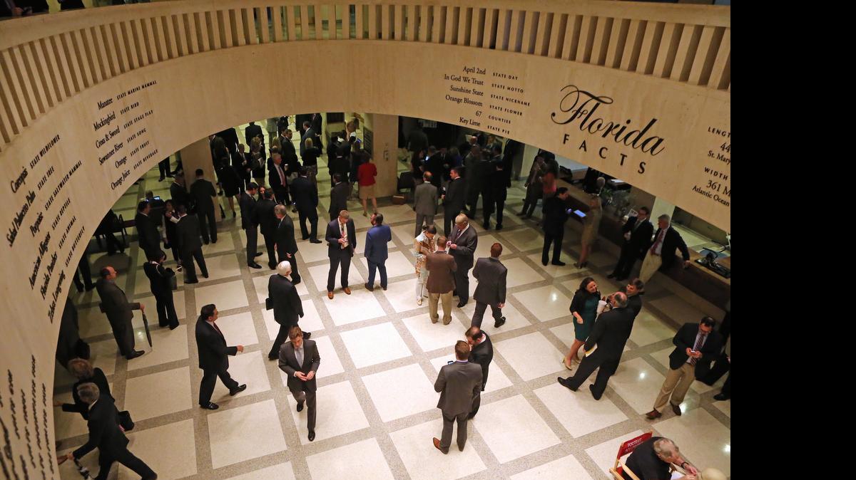 
Lobbyists work in the rotunda between the house and senate chambers during session, Tuesday, April 28, 2015, at the Capitol in Tallahassee, Fla. The Florida House adjourns its annual session three days early because of a budget impasse with the Senate over Medicaid expansion. 
