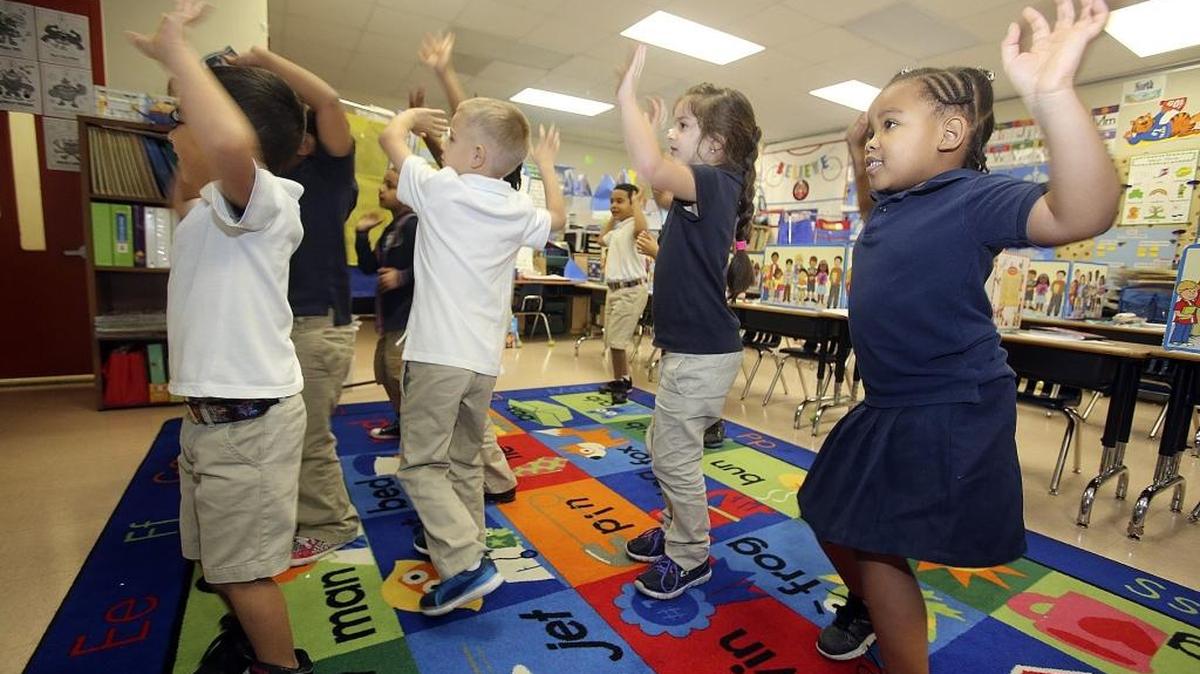 Jedidiah Jeune, right, joins fellow kindergartners in Ching Chong’s class at the David Lawrence Jr. Primary Learning Center in North Miami as they move along to a GoNoodle online routine shown on a classroom screen, on Friday, March 18, 2016. Starting in 2017-18, K-12 students in Florida will be able to attend any public school in the state that has space available.