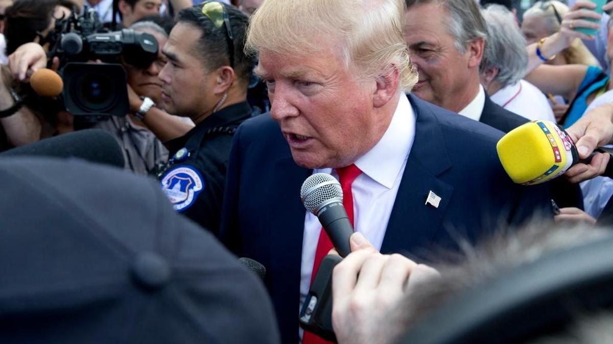 
Republican presidential candidate Donald Trump works his way through the crowd and media during a rally organized by Tea Party Patriots in on Capitol Hill in Washington, Wednesday, Sept. 9, 2015, to oppose the Iran nuclear agreement. 
