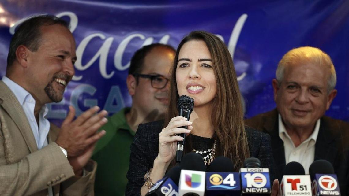 Raquel Regalado stands with brothers Tommy Regalado, left, and Jose Regalado, back, and father, Tomás Regalado, right, after making the runoff election for county mayor in 2016.