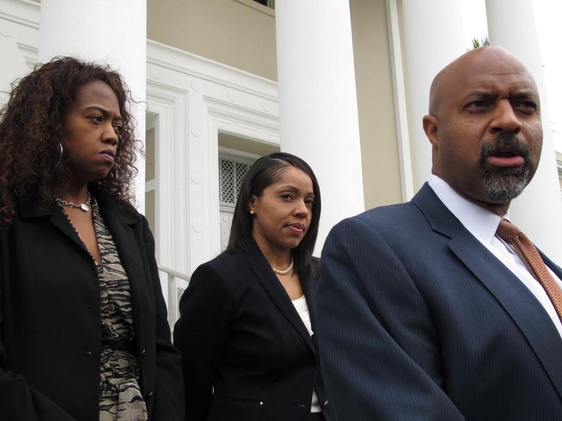 State Attorney Aramis Ayala, center, listens as her lawyer Roy Austin, right, talks to reporters after Austin asked the Florida Supreme Court to return 24 murder cases Gov. Rick Scott reassigned to another prosecutor because Ayala won't seek the death penalty. The court heard arguments Wednesday, June 28, 2017, in Tallahassee.