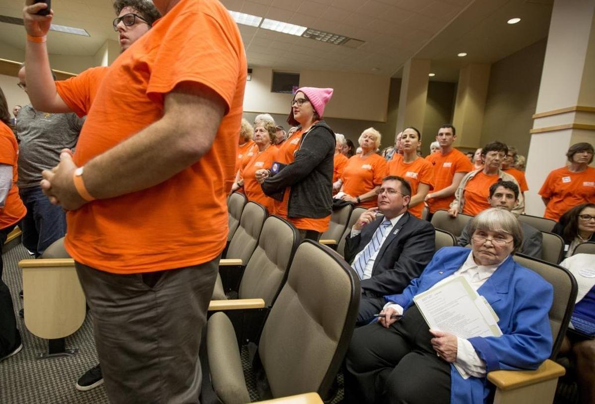 Gun lobbyist Marion Hammer, right, and Eric Friday, general counsel for Florida Carry, sit among protesters during the Senate Rules Committee meeting on gun safety at the Capitol after a rally in Tallahassee on Monday, Feb. 26, 2018.