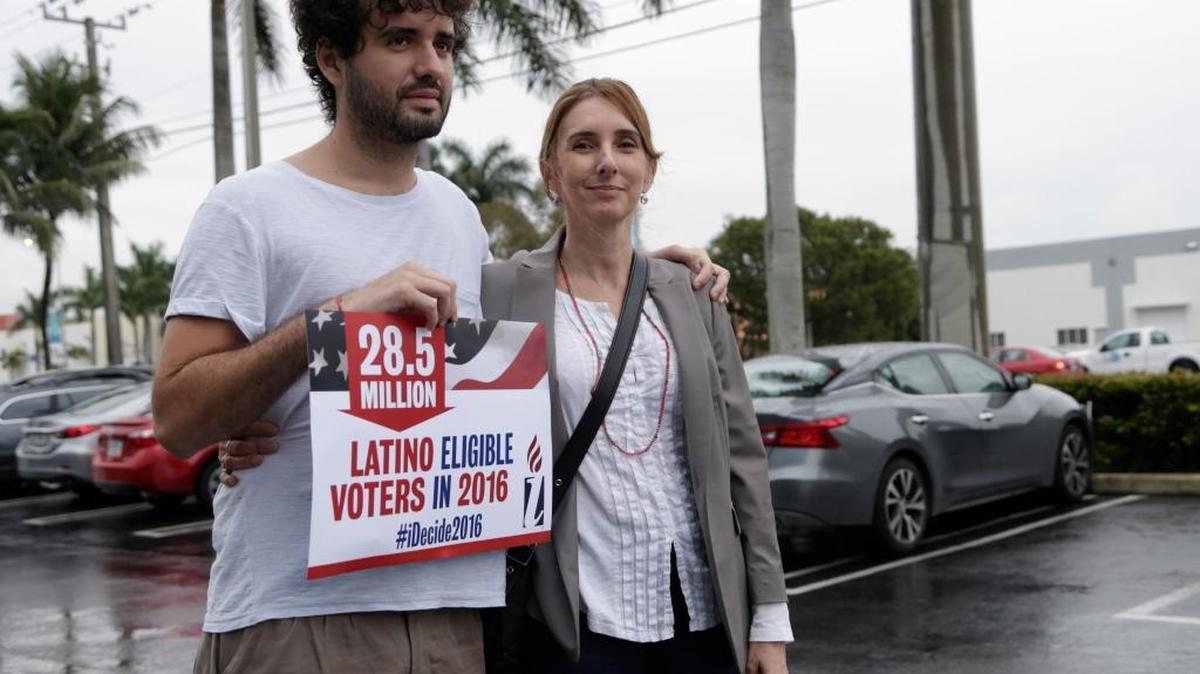 Tomas Kennedy, 24, of Miami, left, poses with his mother, Maria Bilbao, an undocumented immigrant from Argentina, during a protest outside the office of Rep. Carlos Trujillo on Tuesday in Doral. On the opening day of the Florida legislative session, protestors unveiled their agenda for increasing the minimum wage, and pro-immigrant legislation. Kennedy is a resident of the U.S. and will apply for citizenship soon.