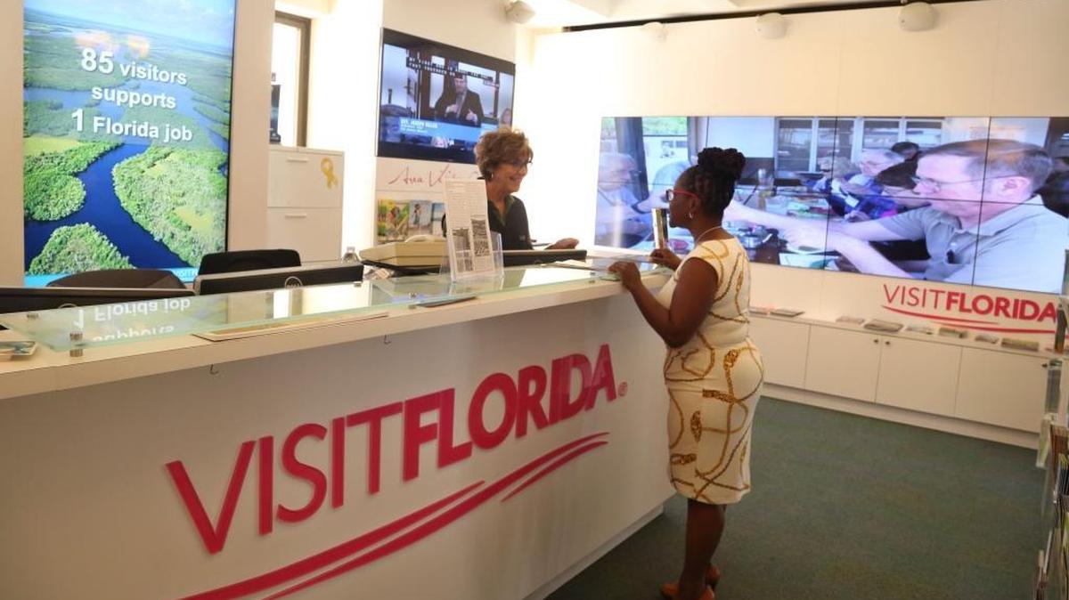 Manager Karen Epstein, left, helps Yolanda Copeland, Jacksonville, with information about African-American history in Florida and travel at the Visit Florida desk at the Florida Capitol.