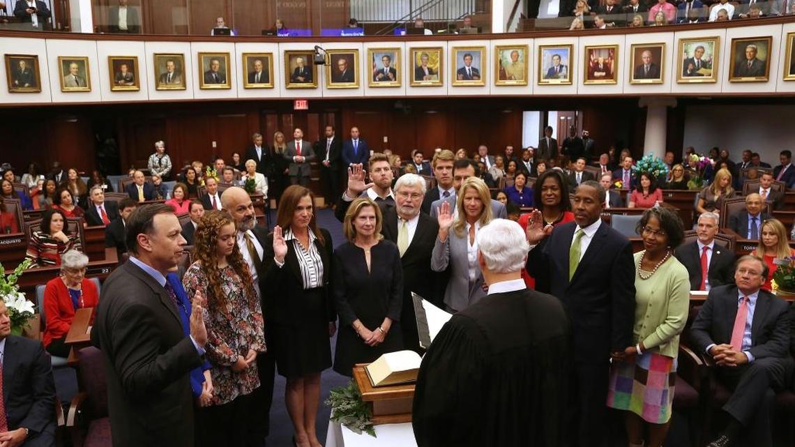 Senators are sworn in by Florida Supreme Court Justice Ricky Polston Tuesday, Nov. 22, 2016, at the Florida House, in Tallahassee, Fla. From left standing with their family members are Sens. Tom Lee, Victor Torres, Dana Young, Jack Latvala, Debbie Mayfield, and Darryl Rouson.