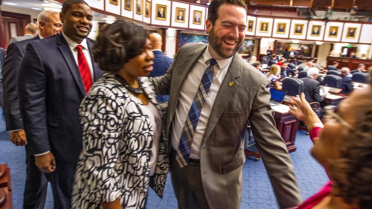 Florida House of Representatives members line up to congratulate Rep. Jose Felix Diaz, R-Miami, after he gave his farewell speech on the floor Monday.