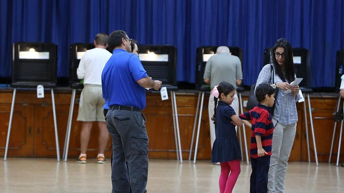 Ana Fernandez de Castro votes with her 5-year-old twins Abigail and Benjamin in Miami Shores on the presidential primary, March 15, 2016.