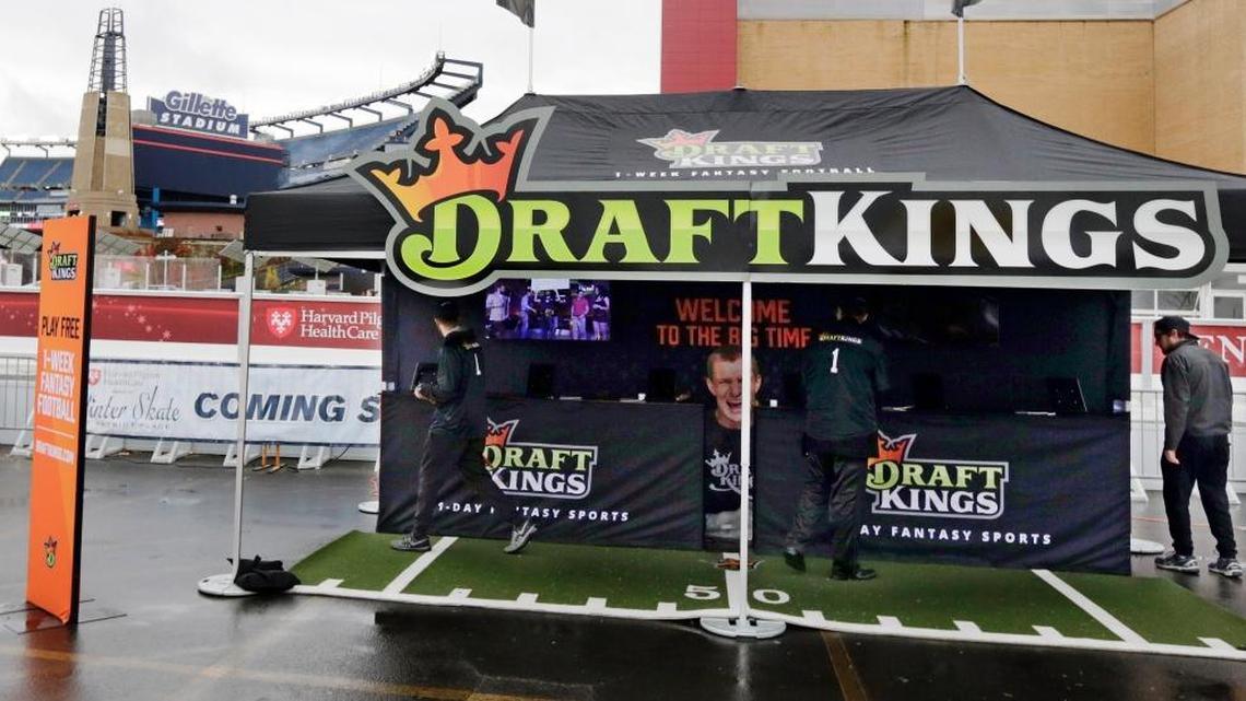 Workers set up a DraftKings promotions tent in the parking lot of Gillette Stadium, in Foxborough, Mass., before a game between the New England Patriots and New York Jets on Oct. 25, 2015.