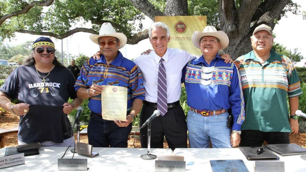 The Seminole Tribe hosted then-Governor Charlie Crist, state Rep. Bill Galvano and other dignitaries at the historic Council Oak tree on tribal land near Hollywood to celebrate the signing of the first compact in 2010. Pictured here (with their roles then): Mitchell Cypress (Chairman, Seminole Tribe of Florida), Richard Bowers (Vice Chairman, Seminole Tribe/President of Seminole Tribe Inc.), Max Osceola (Hollywood Council Representative for the Seminole Tribe of Florida), James Allen (CEO, Seminole Gaming/Chairman of Hard Rock International), with Crist (center) on May 5, 2010.
