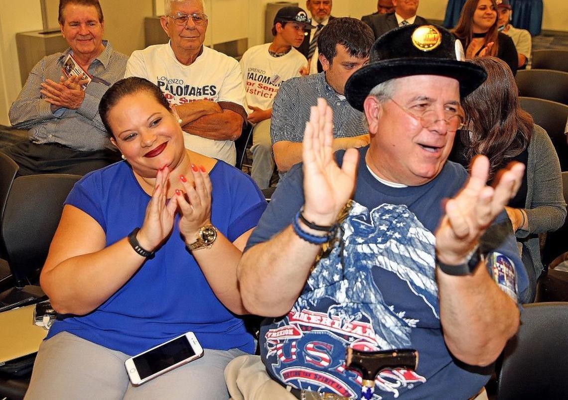 Ana Lacayo and Fermin Vazquez listen to Republican candidates Lorenzo Palomares and Jose Felix Diaz at a candidate forum at Miami-Dade College Kendall Campus, June 19, 2017.