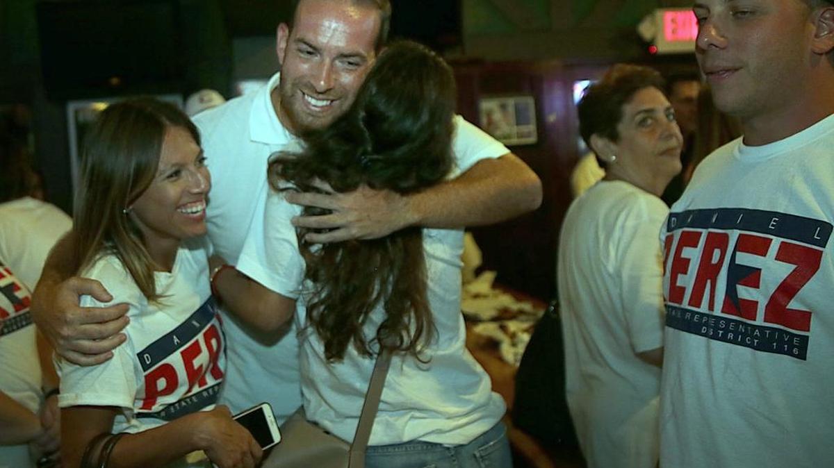 Republican candidate Daniel Perez, celebrates with supporters Gaby Blanco (left) and Olga Cutillas at the Sports Grill in Kendall after his victory in the House District 116 primary.