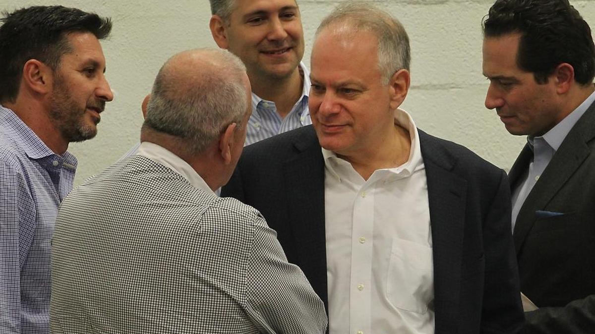 Stephen Bittel, center, chats with voters as members of the Miami-Dade Democratic Party Executive Committee meet in December.
