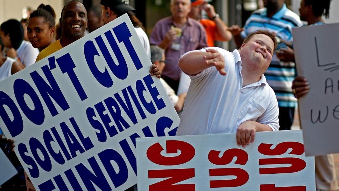 Michael Vaduro, 24, right, dances as music is played during a rally against Gov. Scott’s proposed budget cuts at the Stephen Clark Center on March 8, 2011 in Miami.