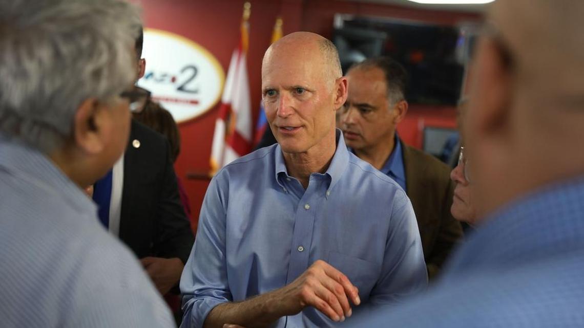 Rick Scott interacts with people at El Arepazo 2 as he holds a bill-signing ceremony for legislation to prohibit all state agencies from doing business with any entity that benefits the Venezuelan regime on March 28, 2018, in Doral.