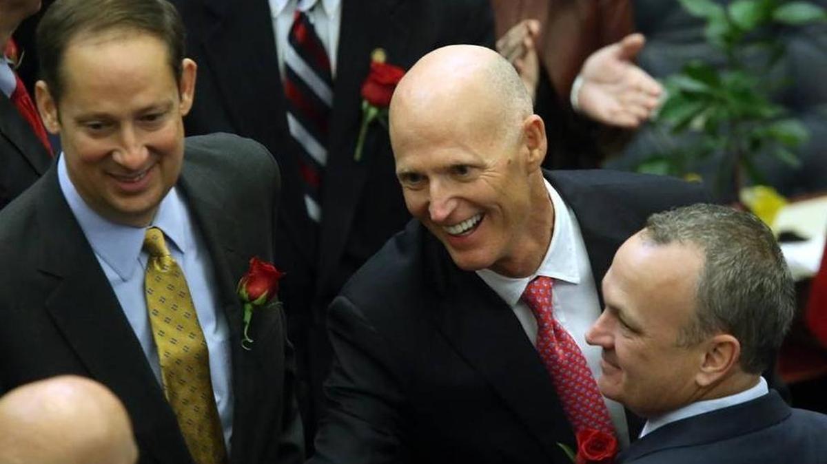 Gov. Rick Scott flanked by Sen. Joe Negron, R-Stuart, left, and Rep. Richard Corcoran, R-Land O’Lakes makes his way to the podium to deliver his 2016 State of the State address on the first day of session.