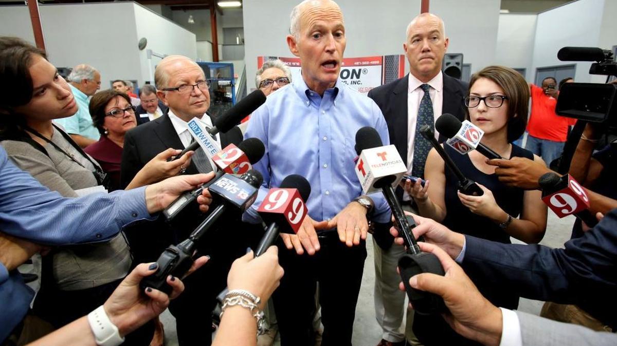 Florida Gov. Rick Scott, center, speaks during a tax cut announcement in Sanford, Monday, Nov. 6, 2017. Scott proposed a $180 million tax cut package that is aimed primarily at residents and not businesses.