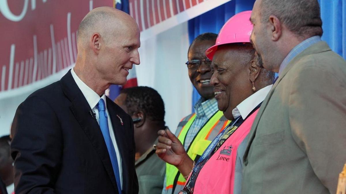 
Florida Gov. Rick Scott congratulates worker Lovette McGill during a press conference at PortMiami on Friday, Sept. 18, 2015, at the ceremonial conclusion of the dredging project.
