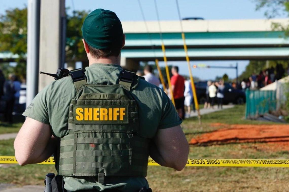 A sheriff’s deputy watches the scene around Marjory Stoneman Douglas High School in Parkland on Wednesday, Feb. 14, 2017.