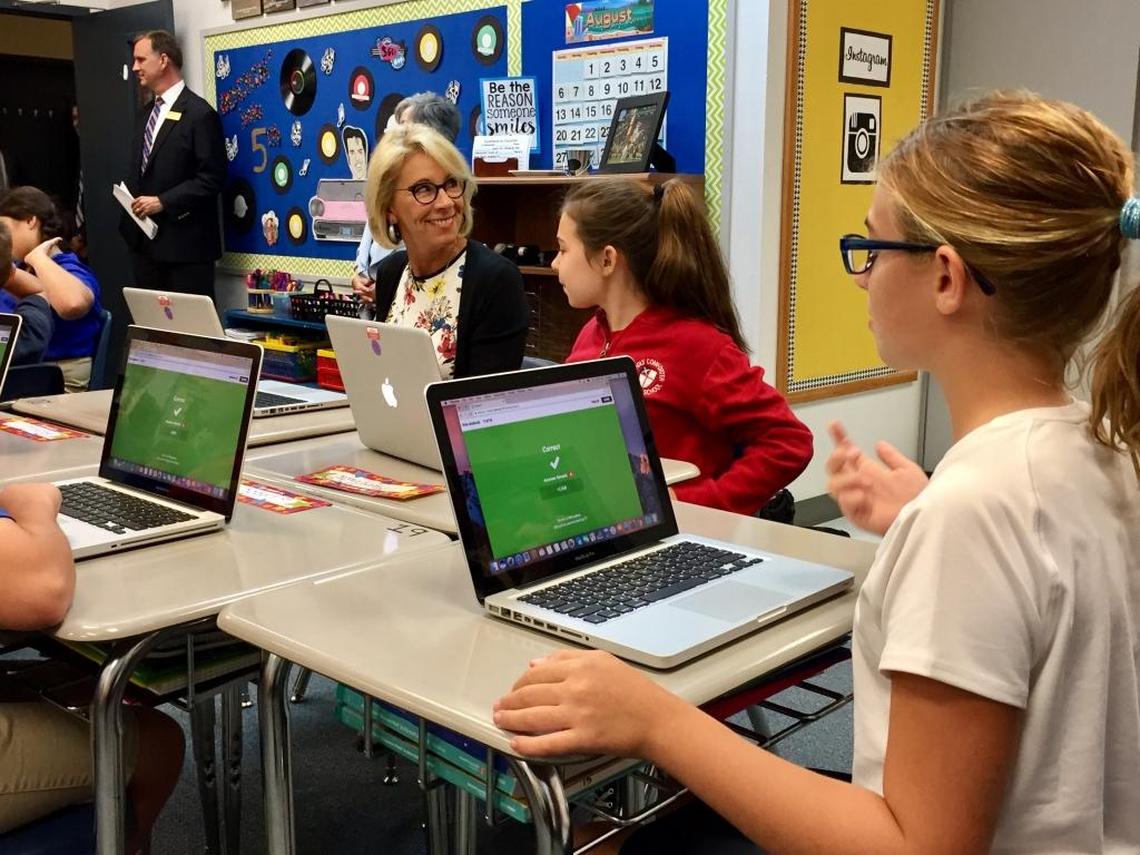 U.S. Education Secretary Betsy DeVos participates in a lesson with fifth grade students at Holy Comforter Episcopal School in Tallahassee on Tuesday, Aug. 29, 2017, as they use an online-learning platform to take a quiz about idioms. DeVos spent two hours visiting classrooms at the private Christian school.