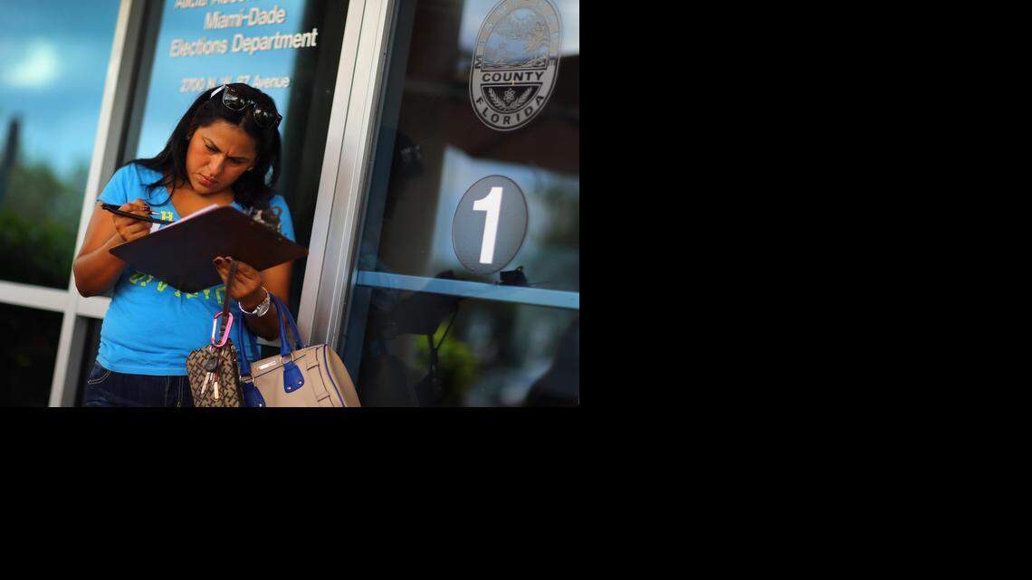 
Ereyda Monge fills out her voter registration form at the Miami-Dade Elections Department in this 2012 file photo.
