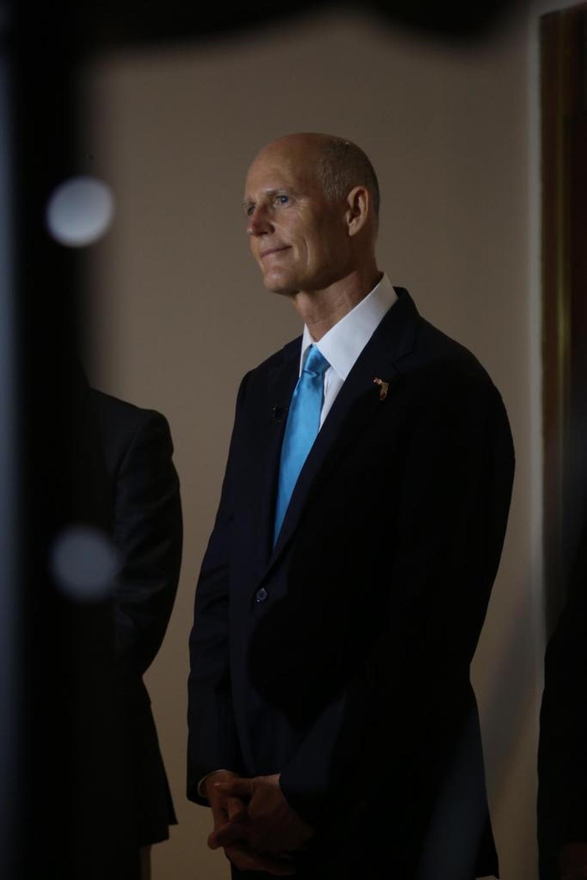 Governor Rick Scott listens during a press conference at Miami International Airport on Friday, June 2, 2017. He still hasn’t committed to signing the K-12 education funding bill.